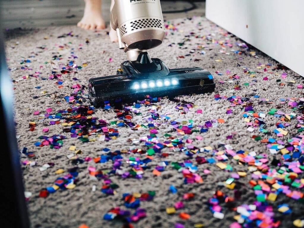 Vacuum Cleaner vacuuming glitter off of a carpet